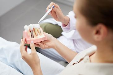 woman looking at implant diagram in lower plenty