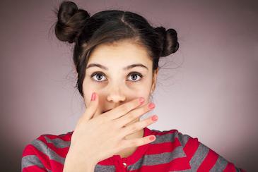 woman hiding teeth | clear aligners in lower plenty