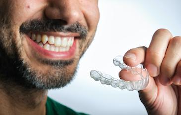 man holding his invisalign | lower plenty dentist